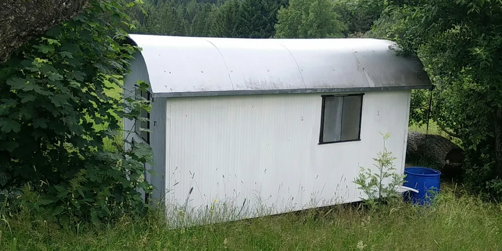 Bauwagen am Rand einer Wiese