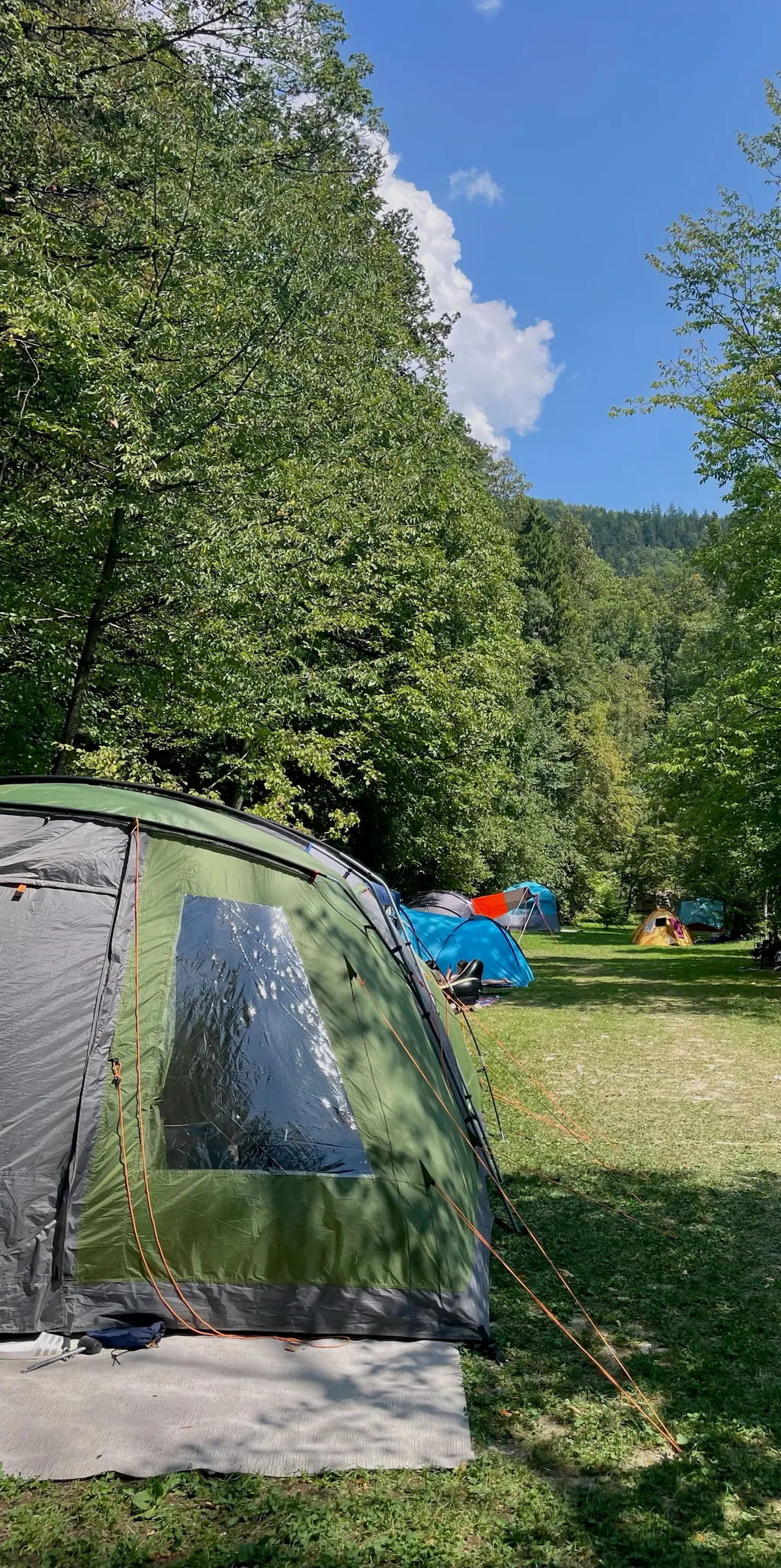 pitch in meadows next to alpine river